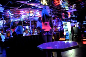 A strip dancer mingles with a customer at the Mons Venus strip club in Tampa